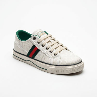 Gucci women's sneakers crafted from white jacquard fabric featuring a small GG pattern and the signature green and red Web stripe CC887.