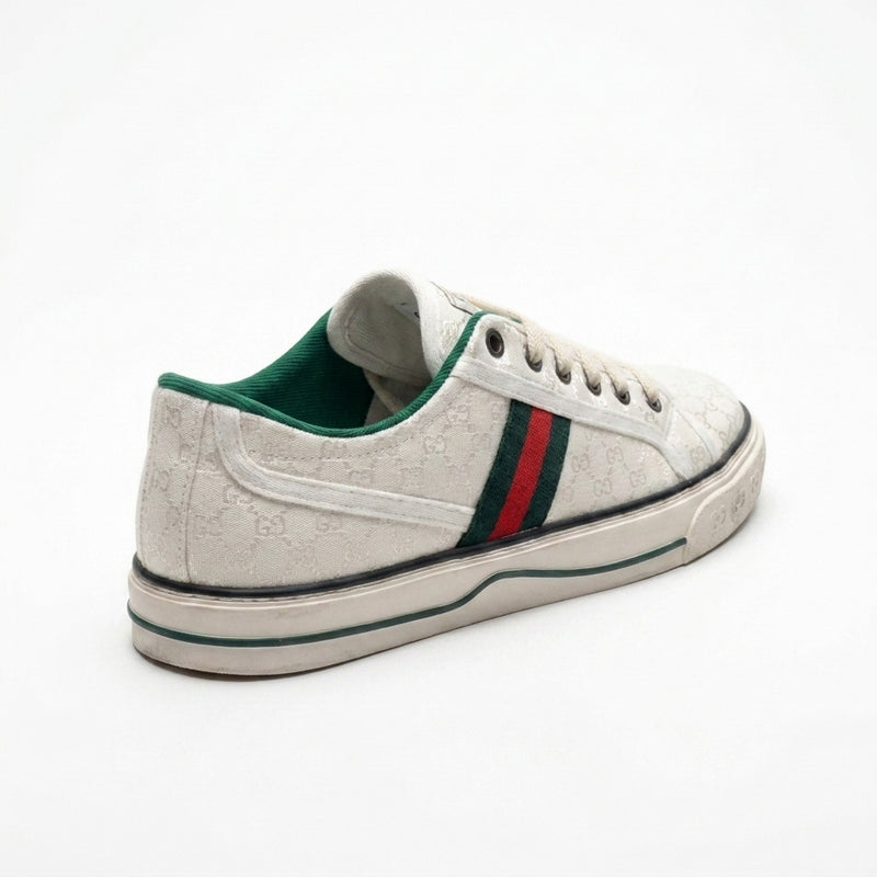 Gucci women's sneakers crafted from white jacquard fabric featuring a small GG pattern and the signature green and red Web stripe CC887. - 2
